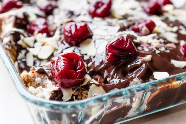 Chocolate Pudding Cake with Cherries, Almond Slices and Biscuits — Stock Photo, Image