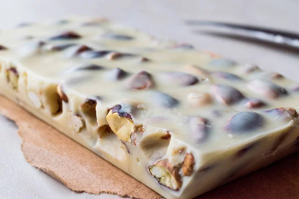 White Chocolate Piece with Pistachio on Marble Surface. — Stock Photo, Image