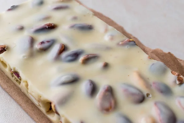 White Chocolate Piece with Pistachio on Marble Surface. — Stock Photo, Image