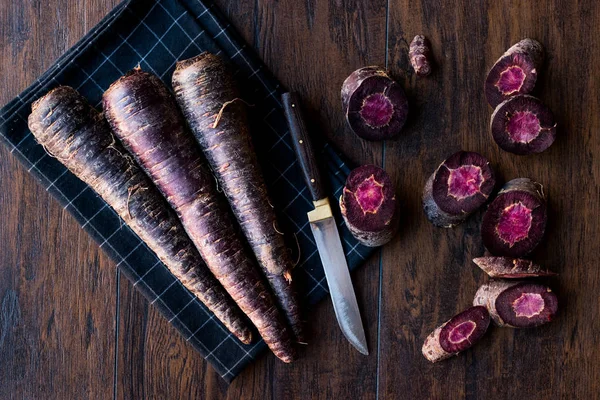 Purple Carrots on Dark Wooden Surface. — Stock Photo, Image