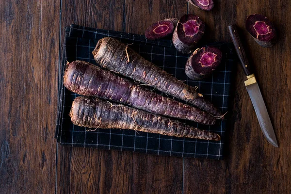 Purple Carrots on Dark Wooden Surface. — Stock Photo, Image