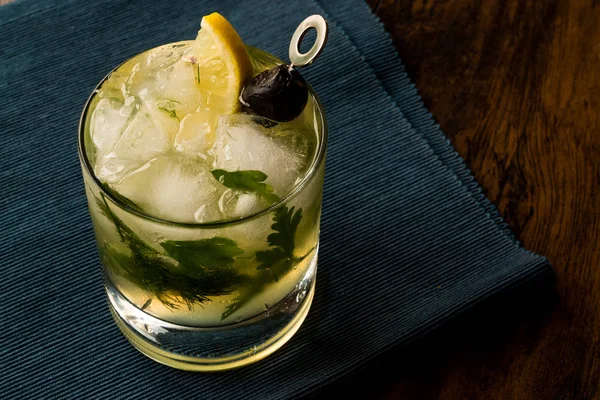 Dillionaire Cocktail with Dill, Gin, Parsley, lemon, Olive and Crushed Ice. — Stock Photo, Image