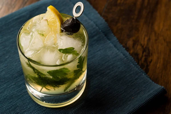 Dillionaire Cocktail with Dill, Gin, Parsley, lemon, Olive and Crushed Ice. — Stock Photo, Image
