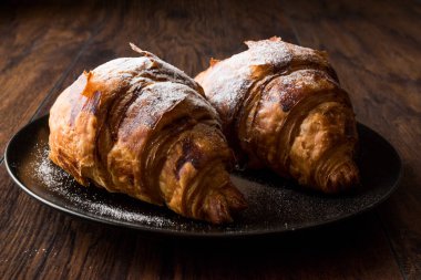 Kruvasan ile pudra şekeri serpilir