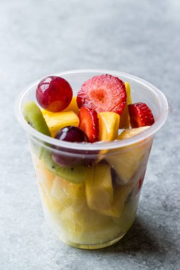 Çilek, kivi, Mango ve plastik kap içinde üzüm meyve salatası.