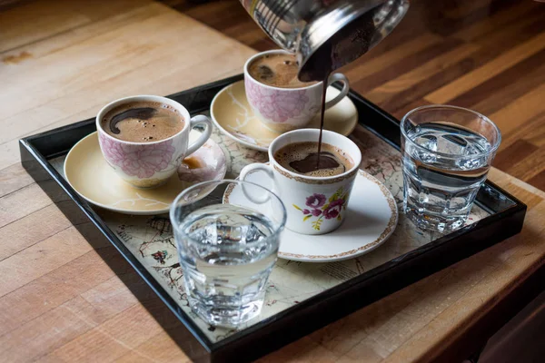 Pouring Turkish Coffee served with water in tray. — Stock Photo, Image