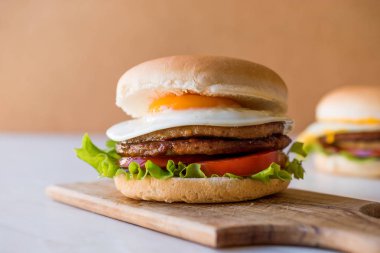 Yumurta, marul ve domates ile çift ev yapımı Hamburger.