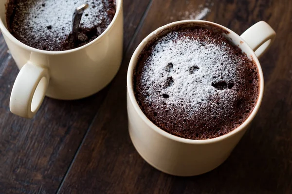 Microwave Brownie Chocolate Mug Cake with Powder Sugar on Dark Wooden Surface. — Stock Photo, Image