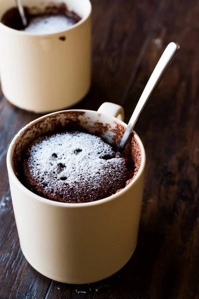 Microwave Brownie Chocolate Mug Cake with Powder Sugar on Dark Wooden Surface. — Stock Photo, Image