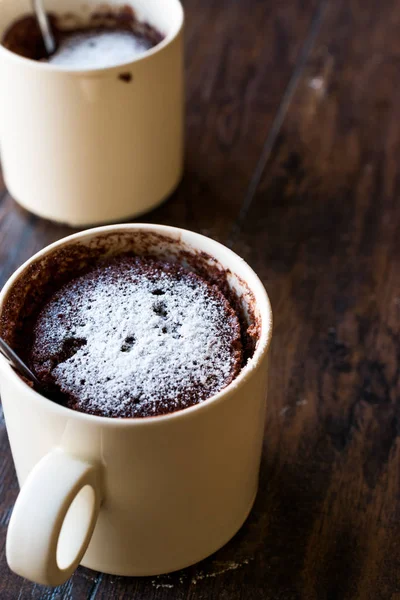 Microwave Brownie Chocolate Mug Cake with Powder Sugar on Dark Wooden Surface. — Stock Photo, Image