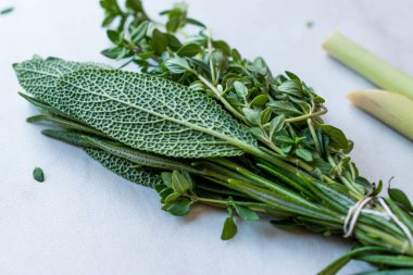 Bitkisel çay yaprakları Lippia, adaçayı, biberiye kekik ve limon ekleyin