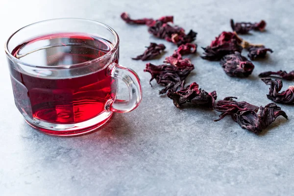 Red Hot Hibiscus Tea in a Glass Mug with Dry Hibiscus Tea Leaves