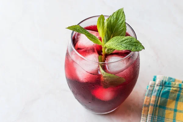 Cold Brew Hibiscus Tea with ice and Mint Leaves.