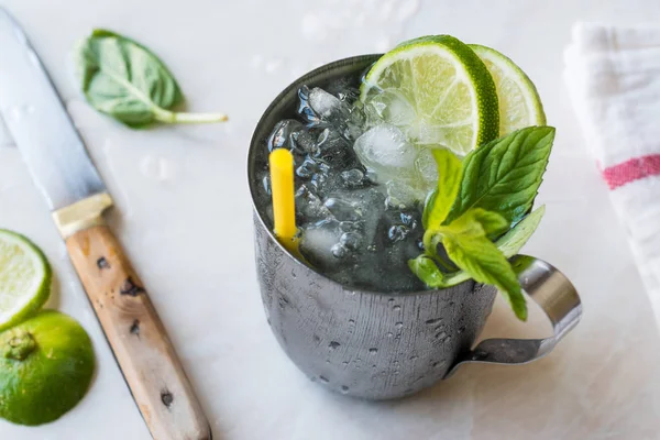Moscow Mule Cocktail with Lime, Mint Leaves and Crushed Ice in Metal Cup
