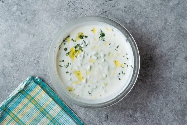 Tzatziki saus / Turkse Cacik yoghurt met plakjes komkommer en olijf olie. — Stockfoto