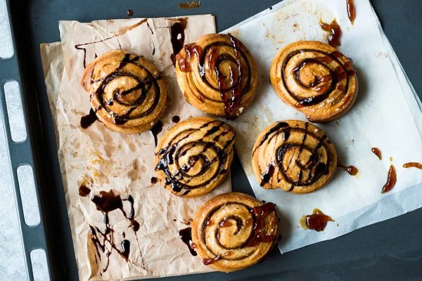 Freshly Baked Cinnamon Rolls with Caramel and Chocolate Sauce. — Stock Photo, Image