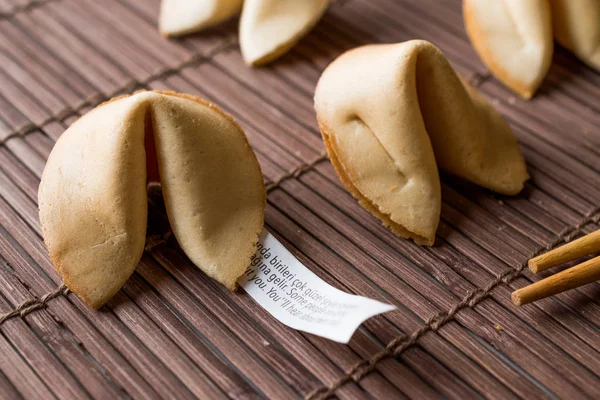 Chinese Fortune Cookies on Bamboo Mat with Chopsticks and Paper — Stock Photo, Image