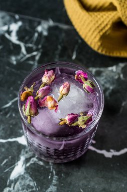 Kurumuş Gül Tomurcukları ve Buzlu Cam Kupa Pembe Cin Tonik Kokteyli.