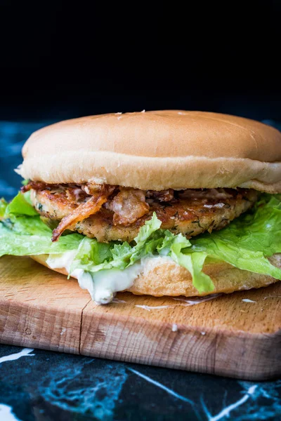 Homemade Salmon Burger with Tartar Sauce, Onion and Lettuce on Marble Board. Ready to Eat. — Stock Photo, Image