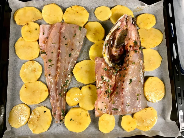 Sciaena Umbra Raw Fish Fillets with Potato Slices on Baking Tray Paper Sheet in Oven / Ready to Bake. Organic Seafood. — ストック写真