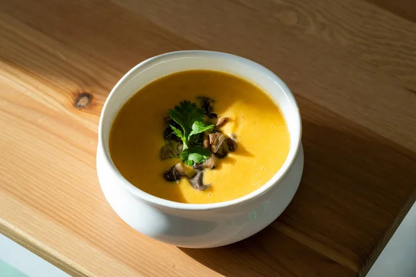Homemade Thai Sweet Potato Soup with Cilantro, Coconut Milk Cream, Lime and Mushrooms. Traditional Beverage Concept.