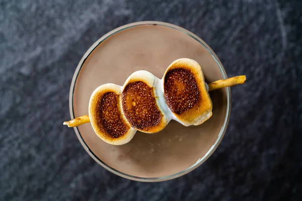 Cooked Marshmallow Cocktail with Pretzel Sticks  also Called Sweet Baby or Babyccino. Confectionery Beverage.