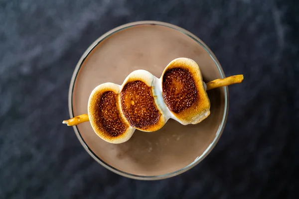 Cooked Marshmallow Cocktail with Pretzel Sticks  also Called Sweet Baby or Babyccino. Confectionery Beverage.