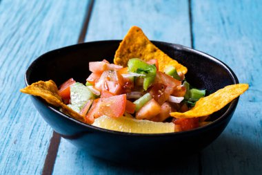 Mexican Food Pico De Gallo Salsa Salad with Tortilla Nachos, Tomato, Onion, Lime, Cilantro, Parsley, Jalapeno Pepper. Healthy Organic Traditional Food.