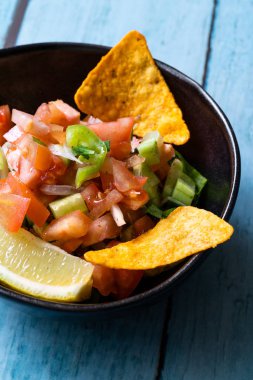 Mexican Food Pico De Gallo Salsa Salad with Tortilla Nachos, Tomato, Onion, Lime, Cilantro, Parsley, Jalapeno Pepper. Healthy Organic Traditional Food.