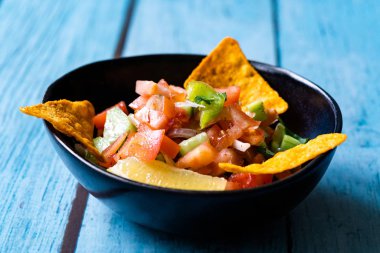 Mexican Food Pico De Gallo Salsa Salad with Tortilla Nachos, Tomato, Onion, Lime, Cilantro, Parsley, Jalapeno Pepper. Healthy Organic Traditional Food.