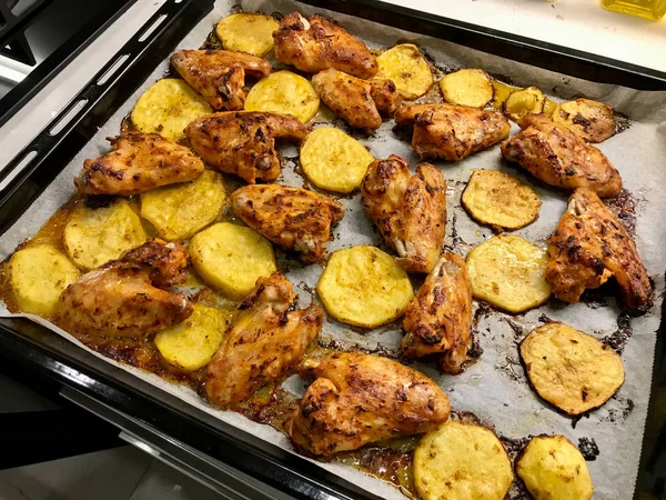 Marinated and Baked Chicken Wings with Potatoes on Baking Tray with Oven Sheet Paper. Ready to Eat. — 스톡 사진