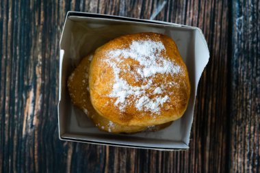 Take Away Mandazi is a slightly sweet East African Street Food; spicy, airy yeast doughnut dough made with coconut milk, flavored with cardamom and grated fresh coconut in Plastic Box Container. Ready to Eat.
