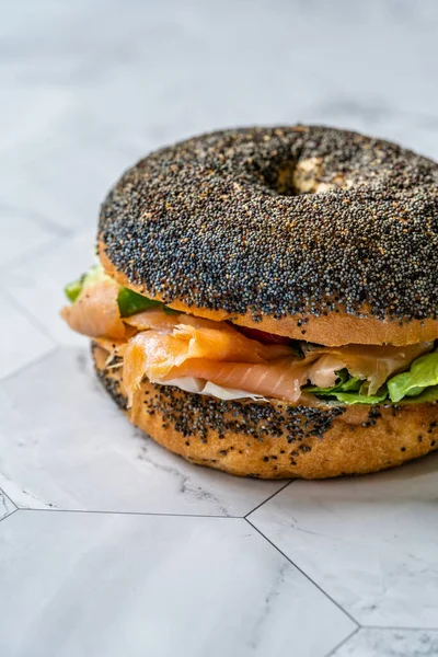 Salmon Bagel Sandwich with Lox Cream Cheese and Poppy Seeds. Organic Healthy Fast Food.