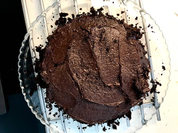 キッチンでグラストレイで調理しながら 上にチョコレートケーキクリームを半分にカット — ストック写真