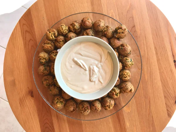 Fresh Mini Falafel Balls with Tahini Hummus Sauce Tahin / Small Roasted Chickpeas for Healthy Appetizer Snacks. Traditional Food.
