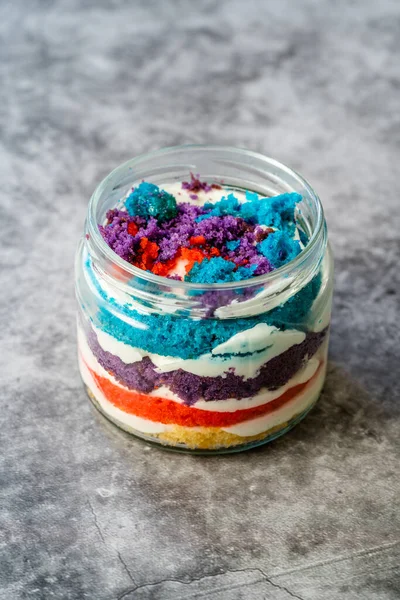 Rainbow Cake Dessert in Glass Jar Flavored with Dragee and Fruits. Ready to Eat.