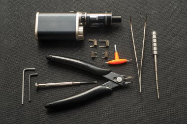 Vape. Araçları tamir ve siyah arka plan üzerine elektronik sigara için. Üstten Görünüm.