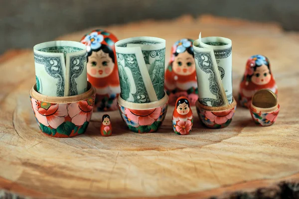 Russian doll with dollars inside. Anti crisis money box. Matrioska bank.