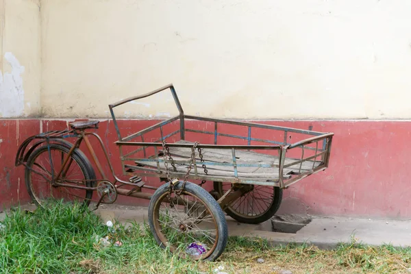 old rusted tricycle used for transporting goods in rural Peru