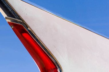 Açık mavi gökyüzü altında klasik bir araba yeri ve kuyruk ışığı