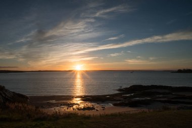 Şafakta okyanus üzerinde güzel gündoğumu Fundy Körfezi 'nde bir plaj