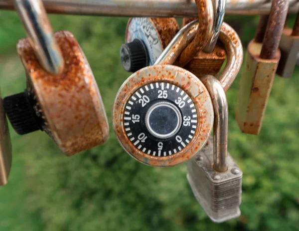 many padlocks on a bridge railing symbolizing eternal love