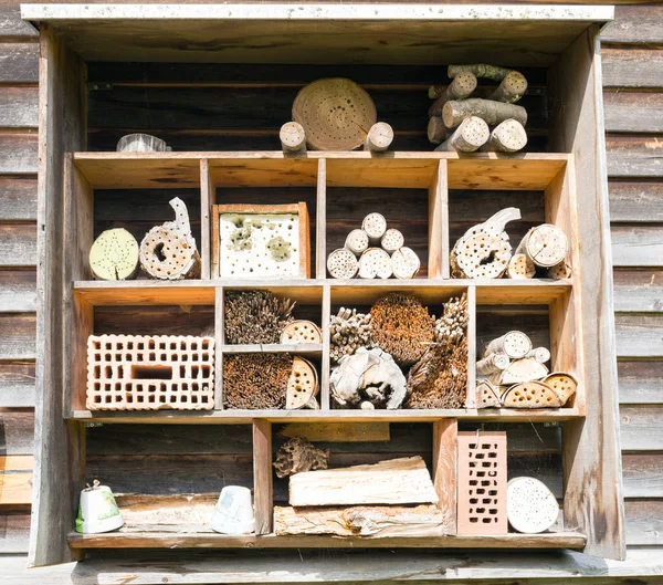 different pieces of wood and brick used for an insect hotel during winter
