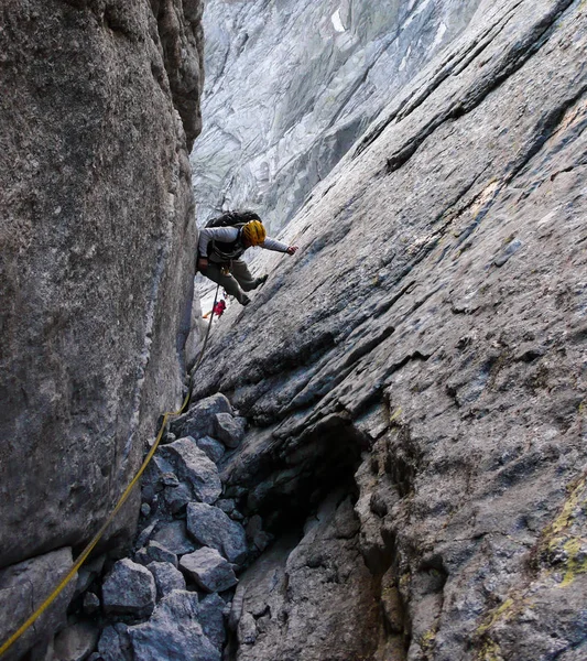 mountain guide on a hard granite climb to a high alpine peak in the Swiss Alps