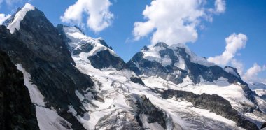 panorama mountain landscape of the Bernina mountain range in Switzerland on a gorgeous summer day clipart