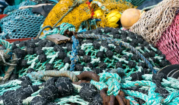 Large pile of different fishing nets used for offshore fishing and trawling laying on the docks — Stock Photo, Image