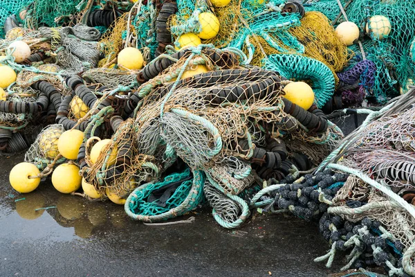 Large pile of different fishing nets used for offshore fishing and trawling laying on the docks — Stock Photo, Image