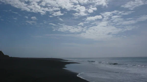 Playa de arena de lava negra en una isla tropical — Foto de Stock