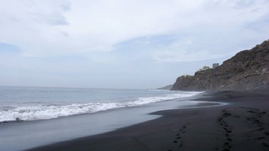  black lava sand beach and jagged wild coastline on Fogo Island in Cape Verde