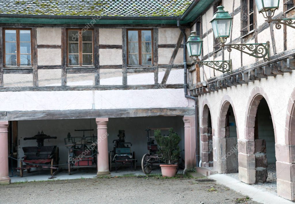 view of a historic half-timbered Alsation country house and cour